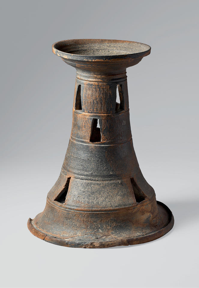 Shallow stand with tall, perforated base