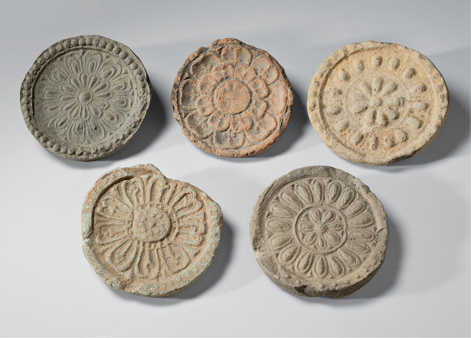 Five roof-end tiles with lotus